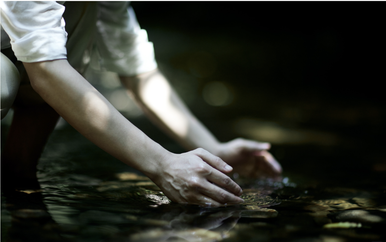 Hands resting in water